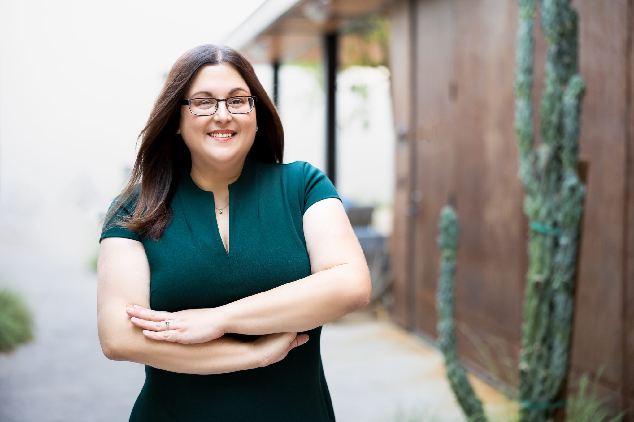 Jaclyn Kliewer, partner at Summit Trial Attorneys, in a dark green dress outdoors