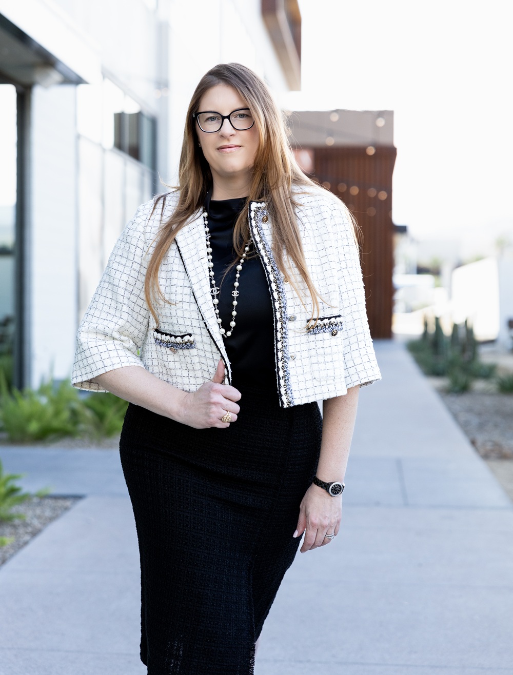 Renee M. Finch, founding partner at Summit Trial Attorneys, standing outdoors in a cream and black jacket