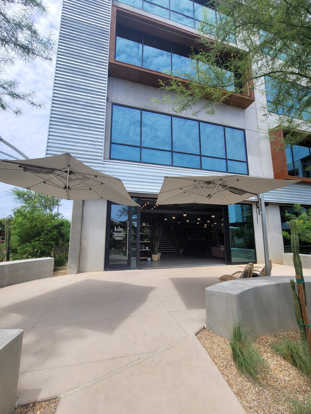 Kiln coworking entrance at UnCommons in Las Vegas, glass doors with kiln. branding and outdoor patio